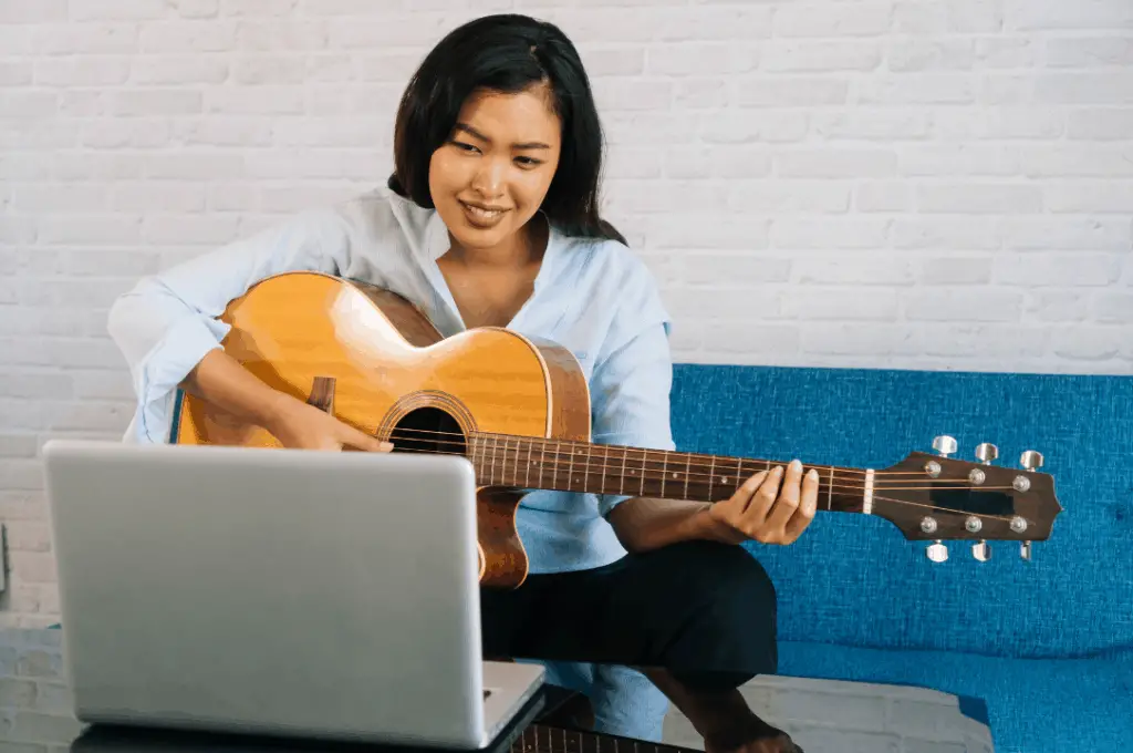 Woman playing guitar chirds