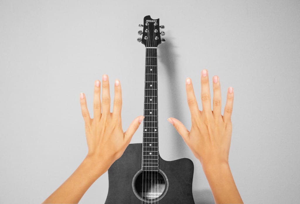 Two hands and an acoustic guitar