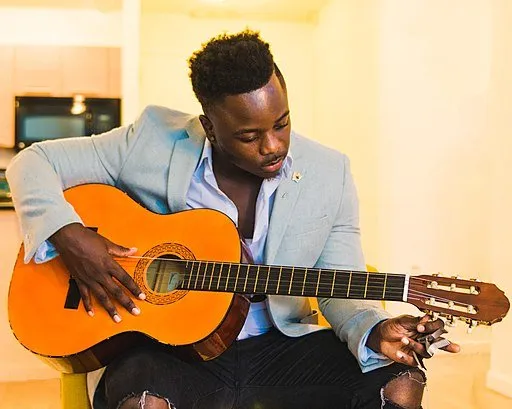 Man tuning a classical guitar