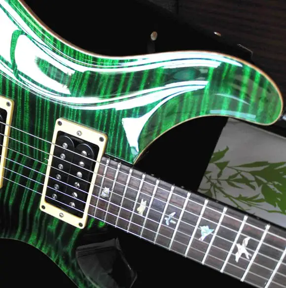 A closeup of a PRS guitar with the famous bird inlays