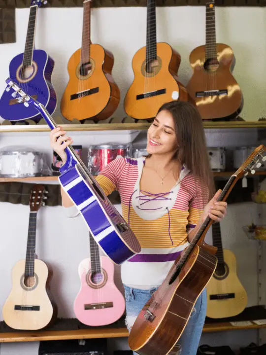 Girl holding two acoustics