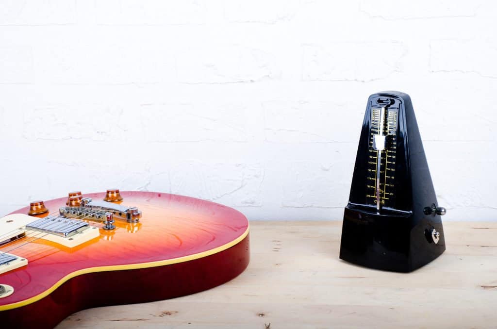 An electric guitar and a metronome