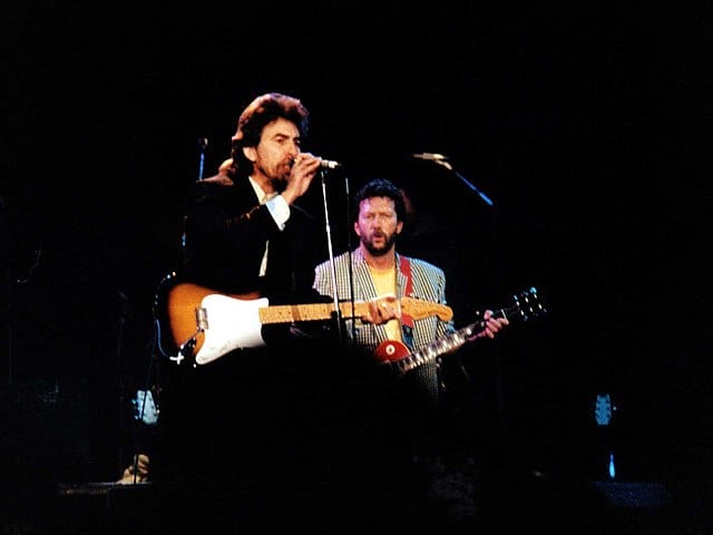 George Harrison and E. Clapton playing live.